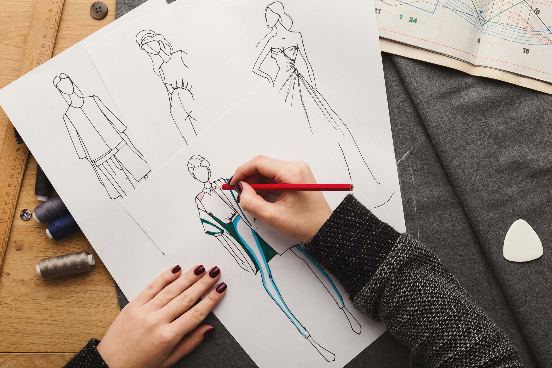 topp-view-on-woman-designer-drawing-clothes-sketche-UEHCSLF.jpg